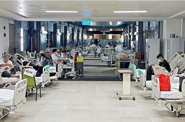  ​Some SGH emergency department patients are housed in a holding area at the linkway between SGH and Outram Community Hospital. PHOTO ST READER 