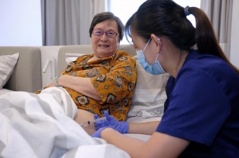 Madam Ang Tua Moi receiving treatment at home by nurse June Tang from Jaga-Me Medical Home Care on April 1, 2022. ST PHOTO THADDEUS ANG