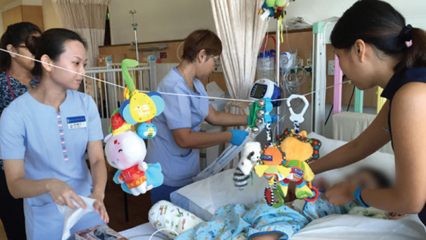  (left to right) Dr Fatima Singaporewalla, SACH; and Nurse Clinician Lee Mei Yi and Dr Cristelle Chow from KKH check on a patient's progress at SACH's paediatric inpatient facility.